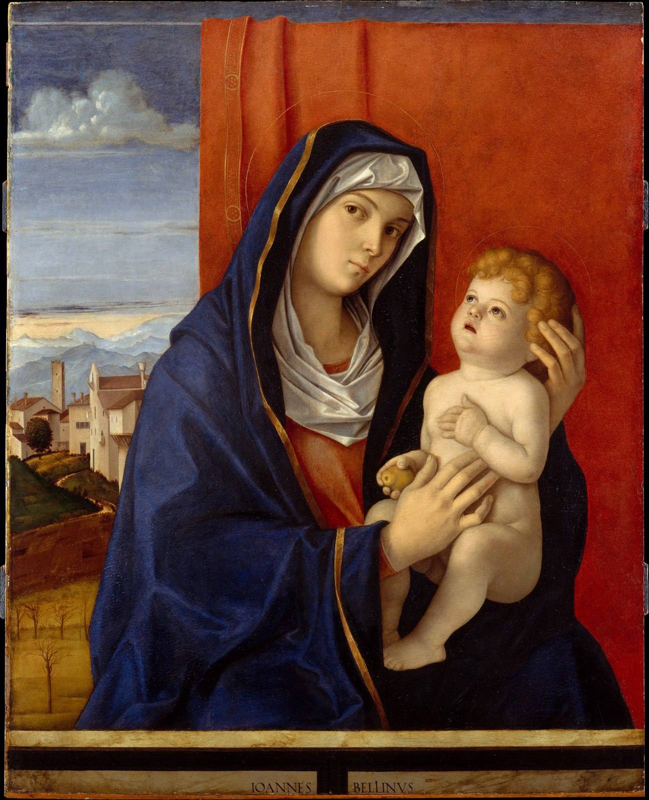 Bellini’s Madonna in a blue mantle holding the Christ child before a red cloth of honour, a distant landscape to the left.