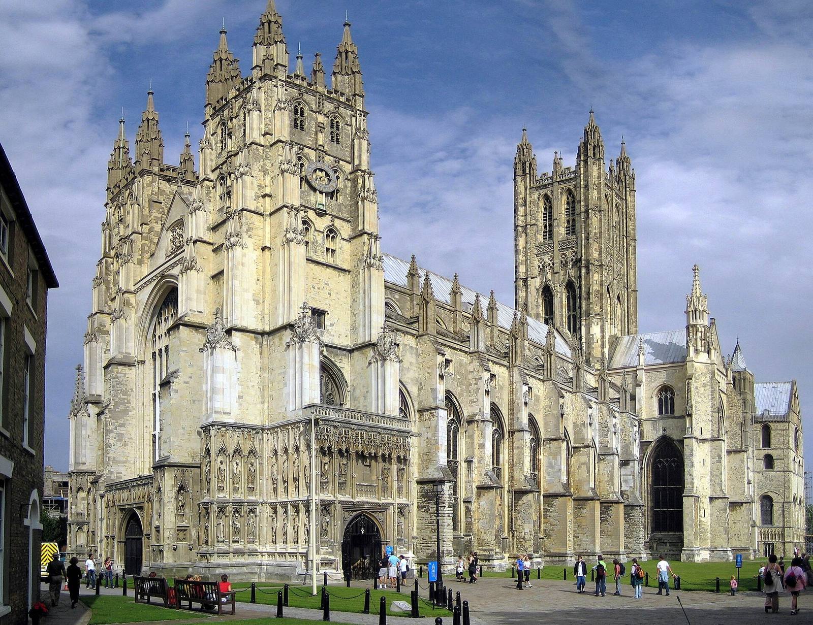Canterbury Cathedral’s pale stone west towers, long nave and tall central tower seen from the south.