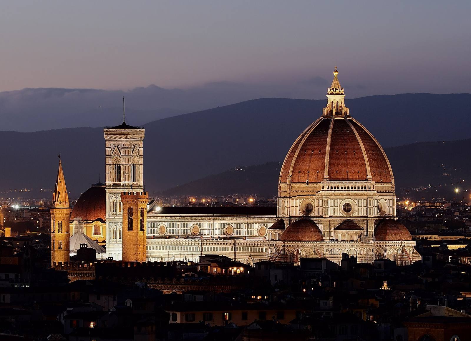 Brunelleschi’s red-tiled dome and Giotto’s bell tower above Florence at dusk.