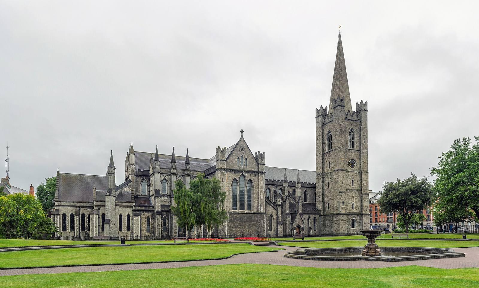 St Patrick’s Cathedral, Dublin, with its tower and spire, seen across a park.