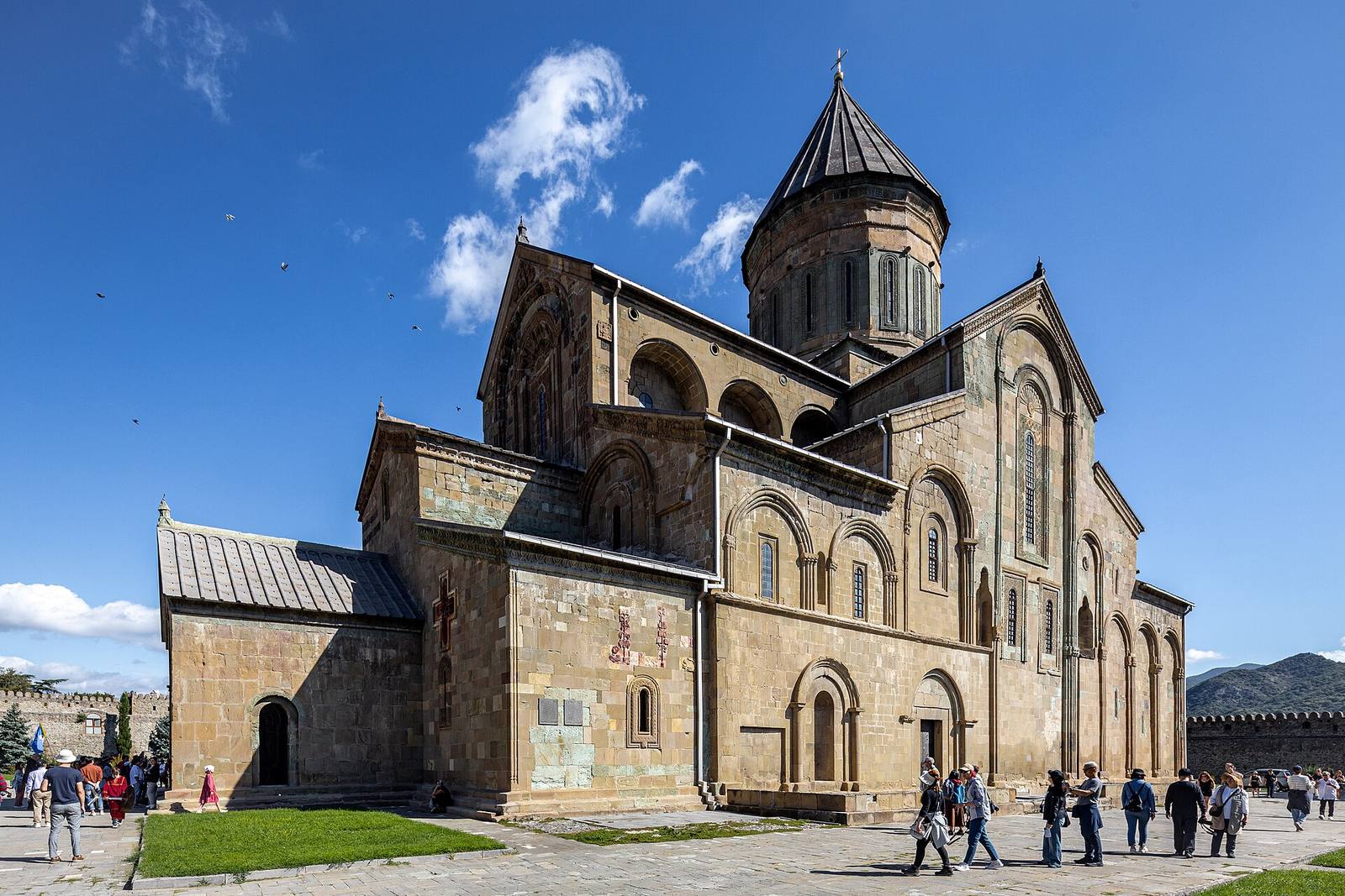 Svetitskhoveli Cathedral’s stone walls and conical-roofed dome inside its enclosure.