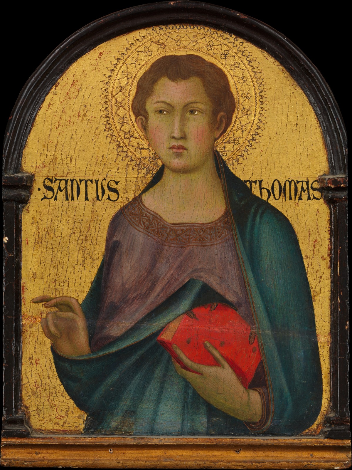 Gold-ground panel of a youthful Saint Thomas with a tooled halo, a red book in his arm, inscribed SANTUS THOMAS.